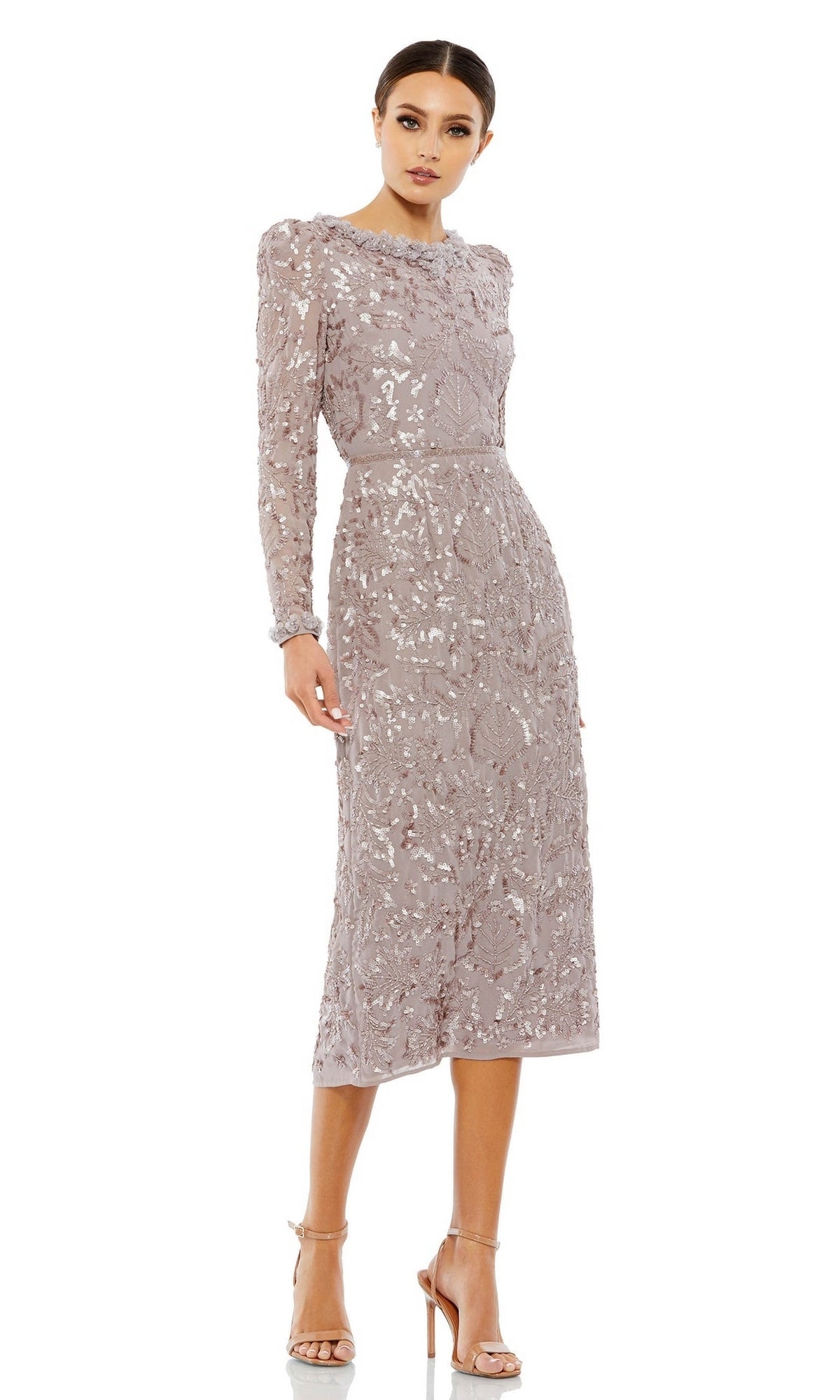 A woman wears the Mac Duggal 93595 Sequin Midi Wedding Guest Dress in light mauve with floral detailing and silver heels—a stunning, long-sleeve option for wedding guests.